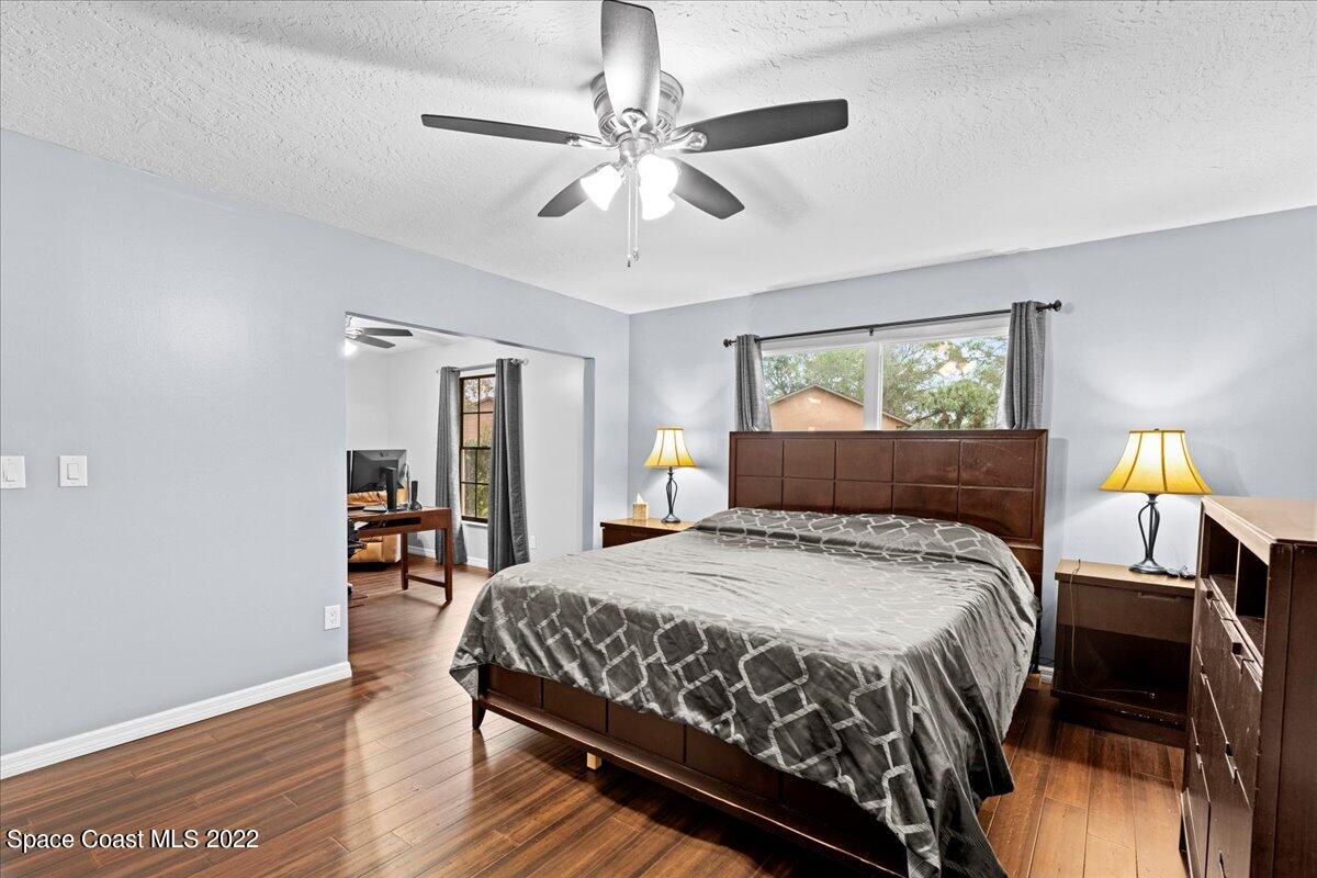 3205 Westland Melbourne, FL 32934 - Photo 18 of 55 a bedroom with a bed and wooden floor