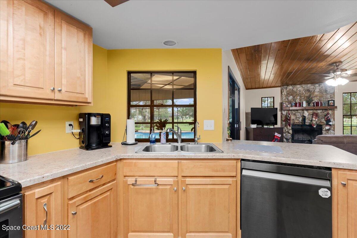 3205 Westland Melbourne, FL 32934 - Photo 22 of 55 a kitchen with stainless steel appliances granite countertop a sink and cabinets