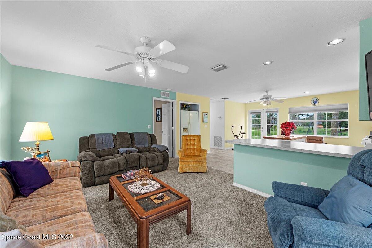 3205 Westland Melbourne, FL 32934 - Photo 28 of 55 a living room with furniture and a wooden floor