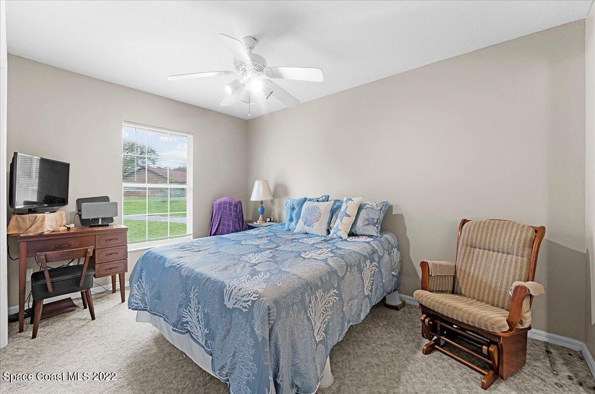 3205 Westland Melbourne, FL 32934 - Photo 31 of 55 a bedroom with a bed and a flat screen tv