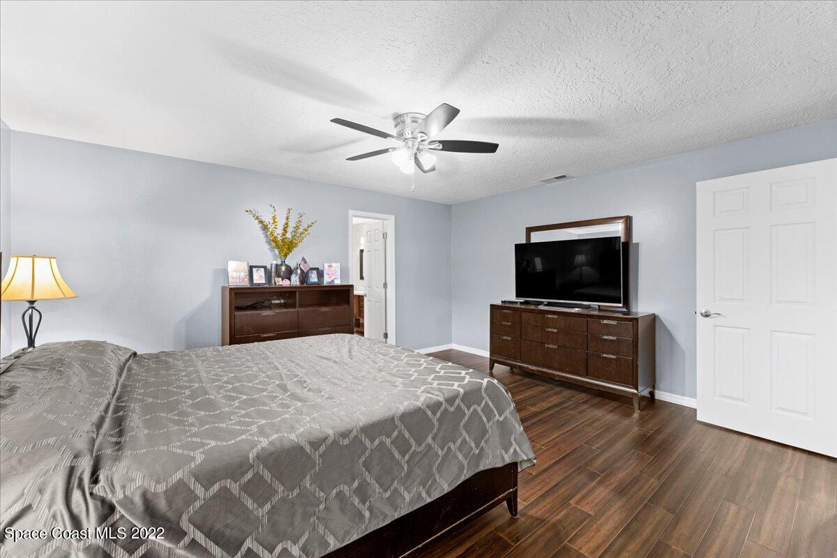 3205 Westland Melbourne, FL 32934 - Photo 38 of 55 a bedroom with a bed and a flat screen tv