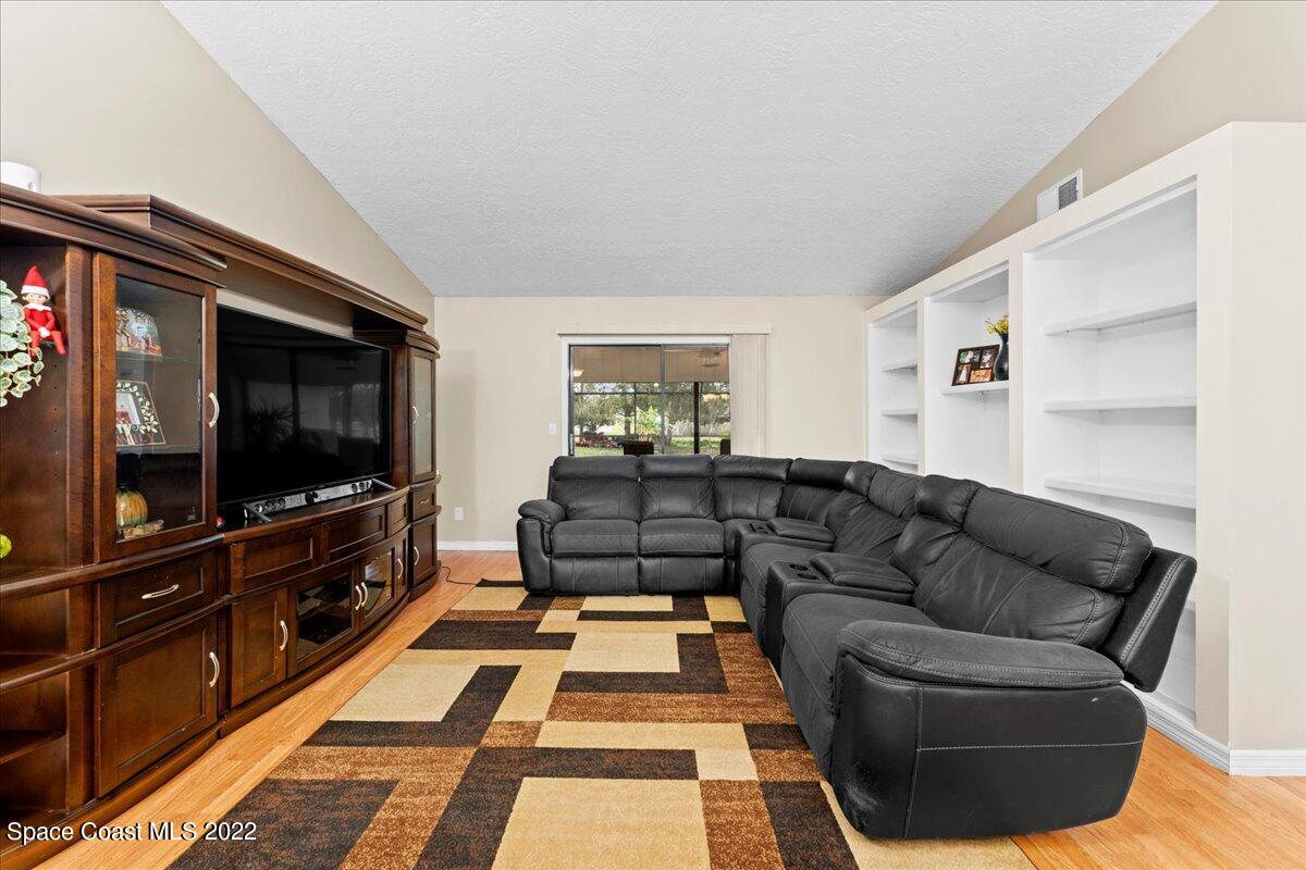 3205 Westland Melbourne, FL 32934 - Photo 8 of 55 a living room with furniture and a flat screen tv