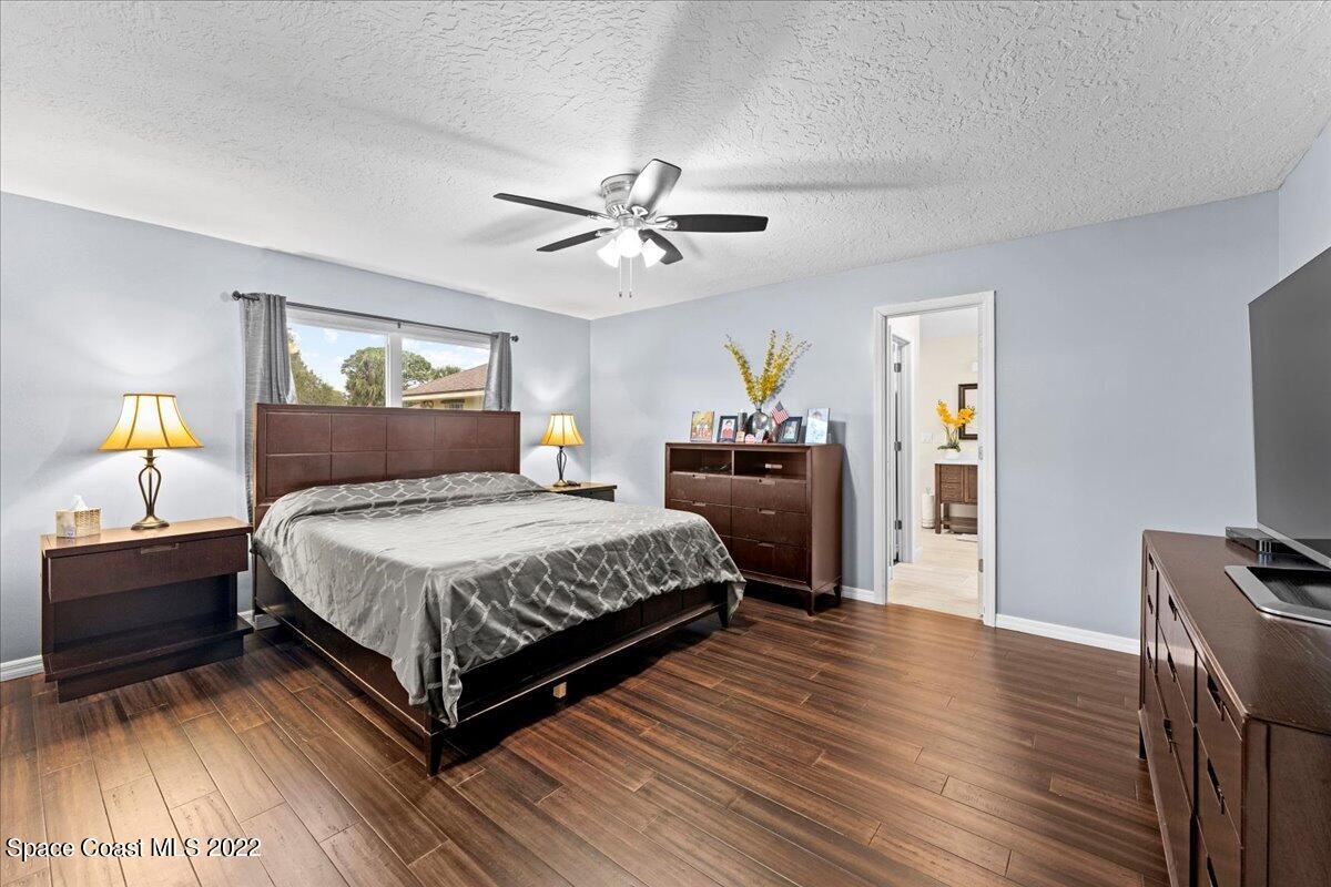 3205 Westland Melbourne, FL 32934 - Photo 9 of 55 a bedroom with a bed and wooden floor