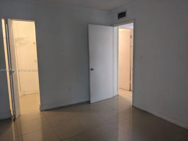 a view of an empty room and a window