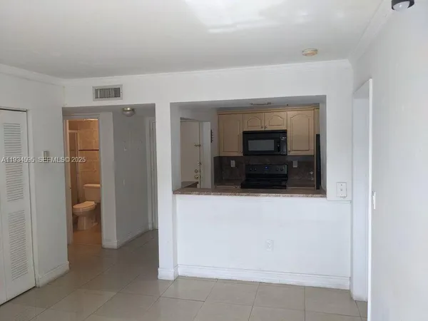 a view of a living room with furniture and a flat screen tv