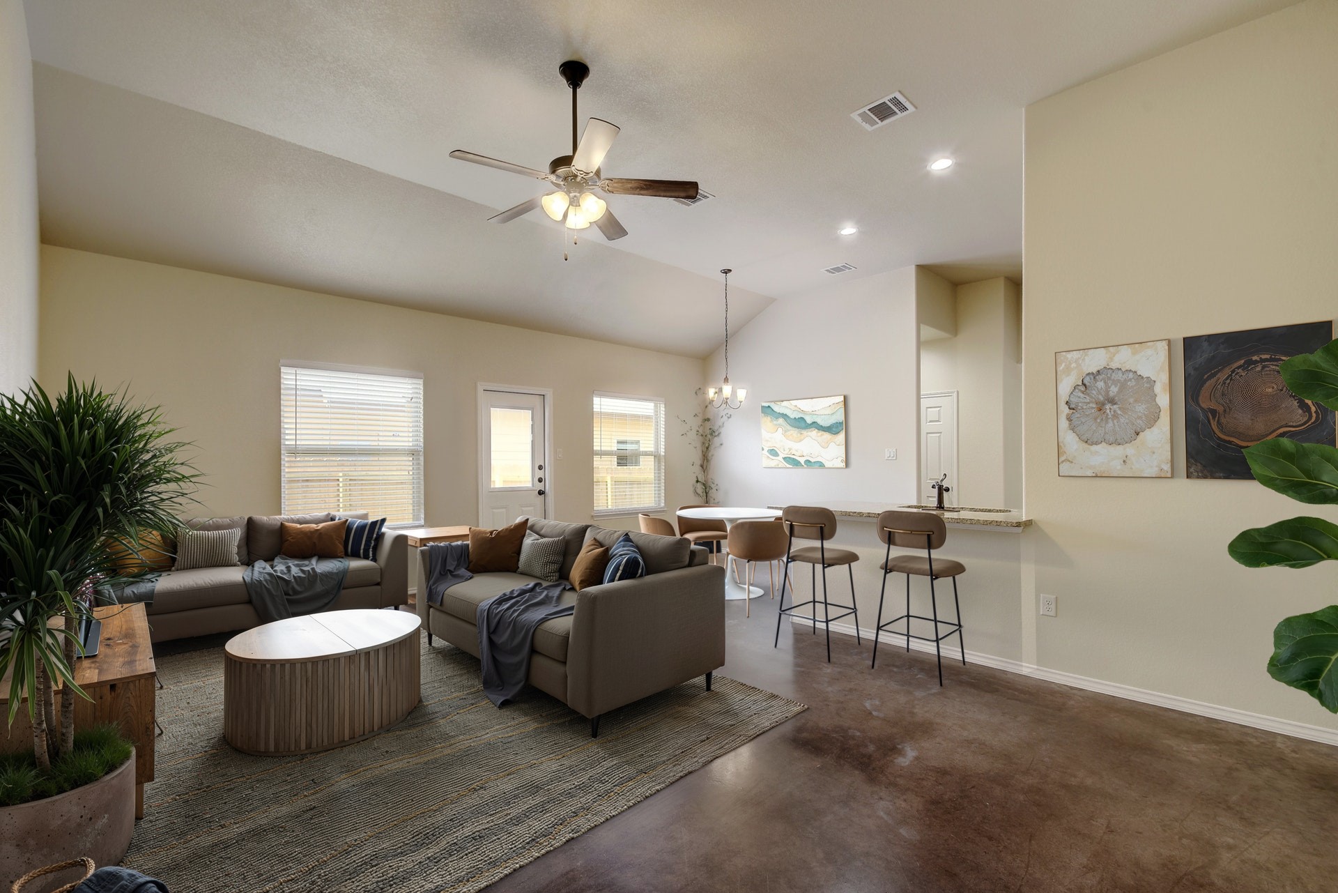467 Jack Rabbit Lane, Unit A Buda, TX 78610 - Photo 3 of 30 Living area with finished concrete flooring, vaulted ceiling, ceiling fan, a chandelier, and recessed lighting