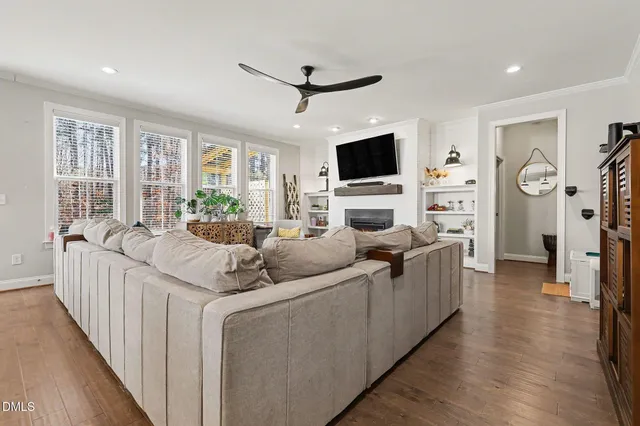 a living room with furniture a rug and a window