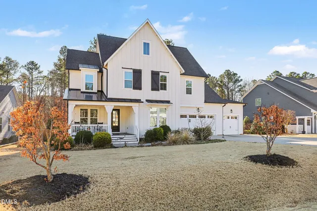 a kitchen with stainless steel appliances kitchen island granite countertop a sink a stove and a refrigerator