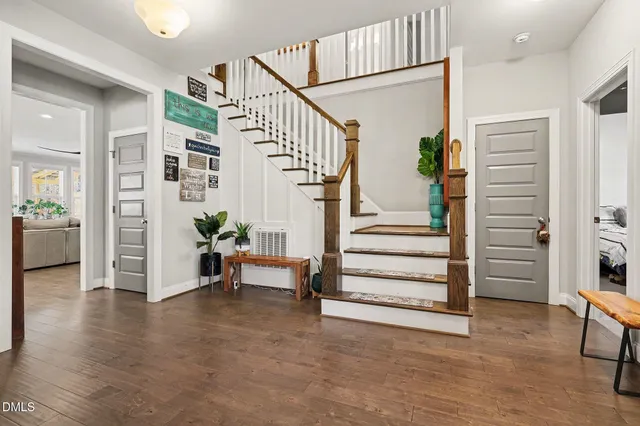 a kitchen with stainless steel appliances a dining table chairs stove refrigerator and cabinets