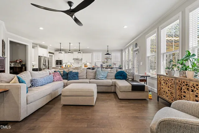 a living room with furniture and a chandelier