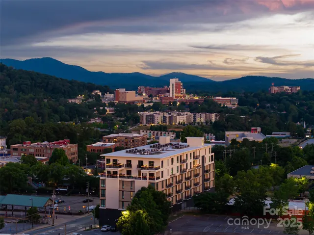 a view of a city & a lots of trees