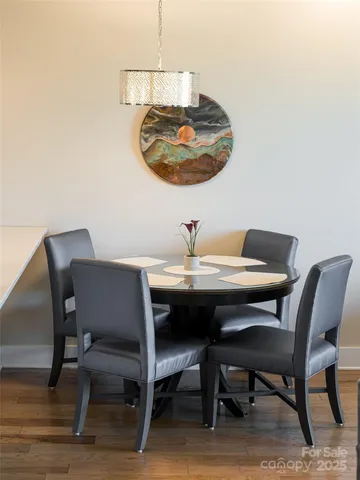a view of a dining room with a table and chairs