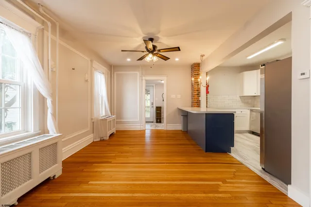 a big room with wooden floor and windows