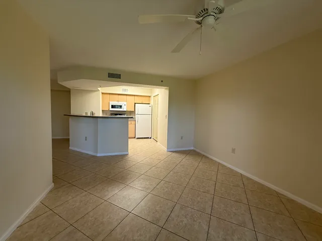 a large kitchen with a stove top oven and cabinets
