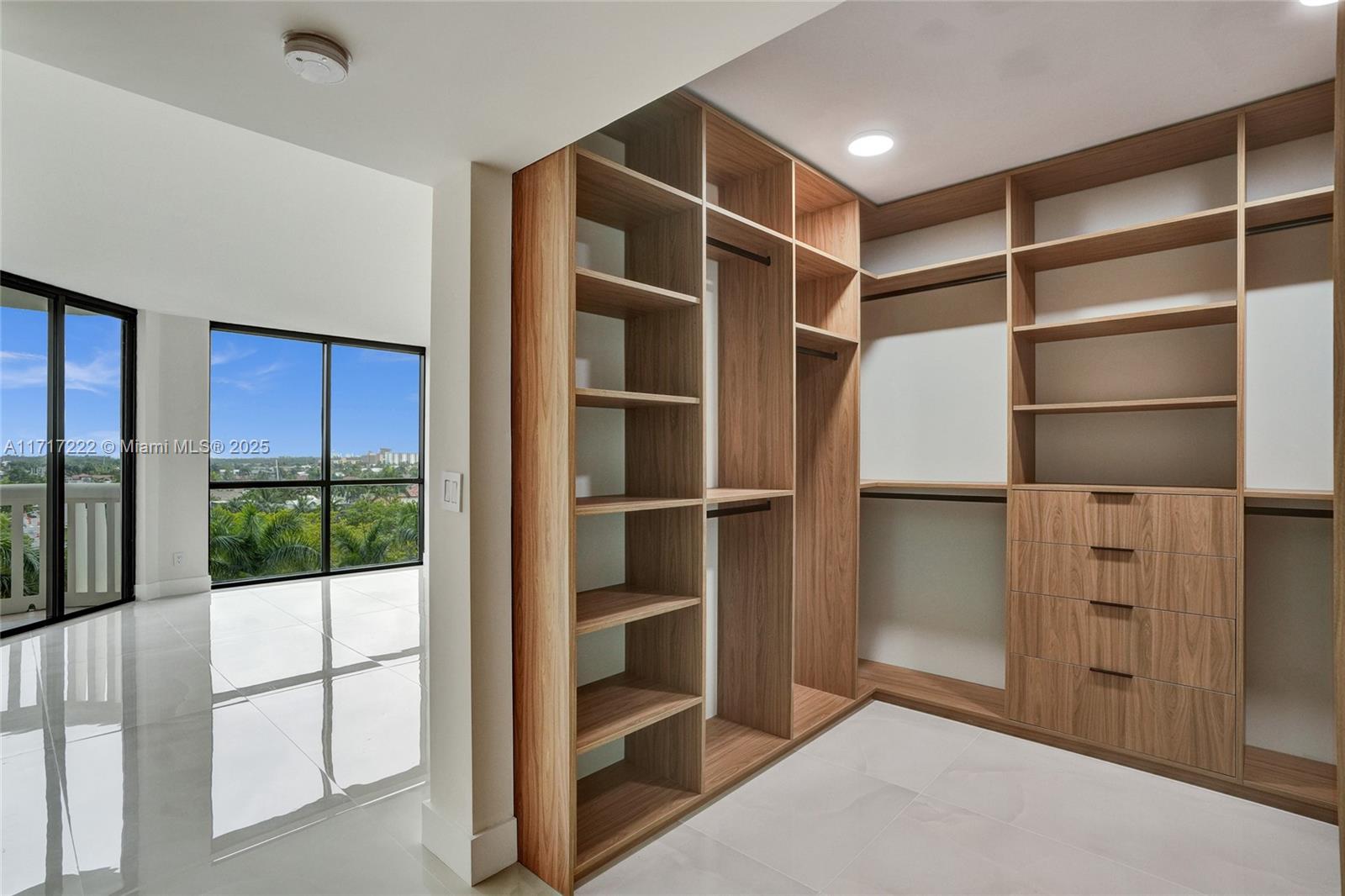 2000 Island Boulevard, Unit 608 Aventura, FL 33160 - Photo 16 of 38 a view of an empty room with cabinet and a floor to ceiling window