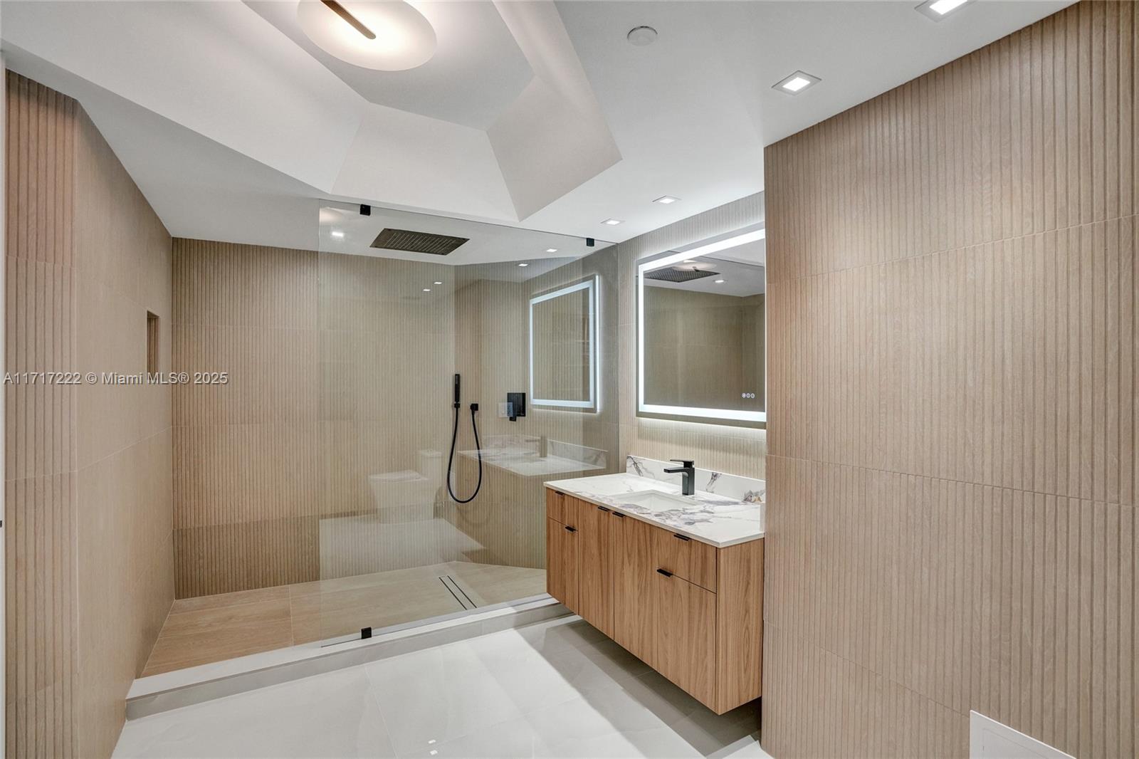 2000 Island Boulevard, Unit 608 Aventura, FL 33160 - Photo 17 of 38 a bathroom with a double vanity sink mirror and shower