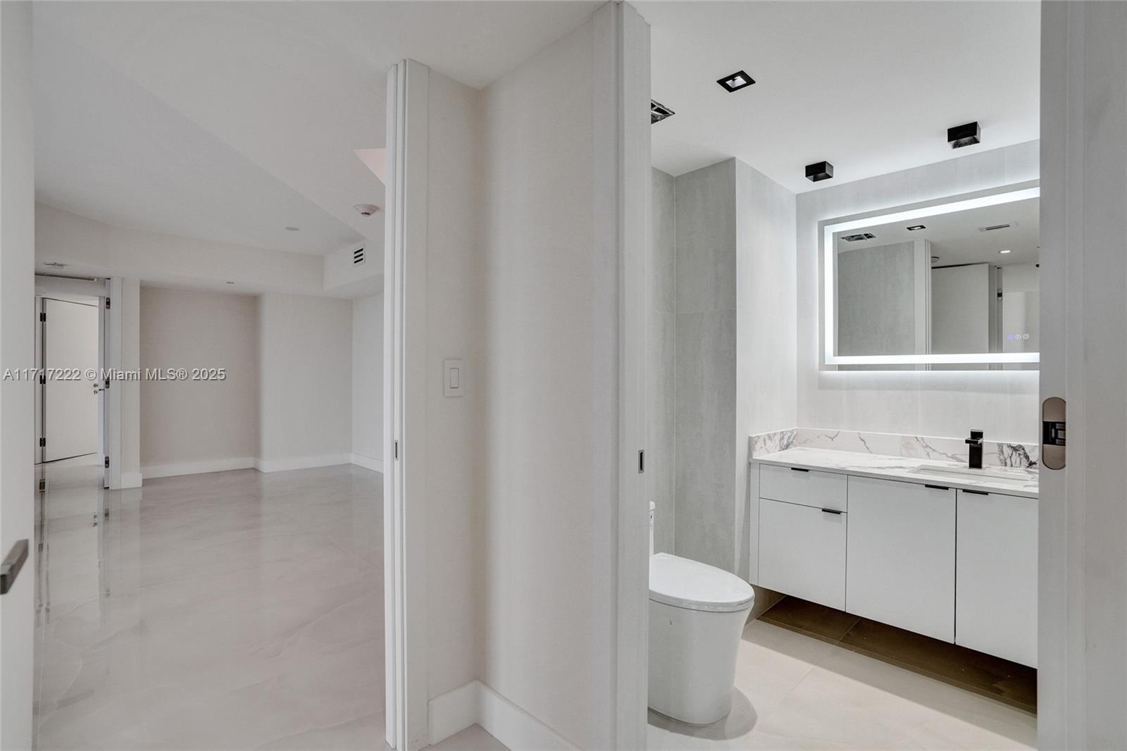 2000 Island Boulevard, Unit 608 Aventura, FL 33160 - Photo 25 of 38 a bathroom with a granite countertop sink a toilet and a shower