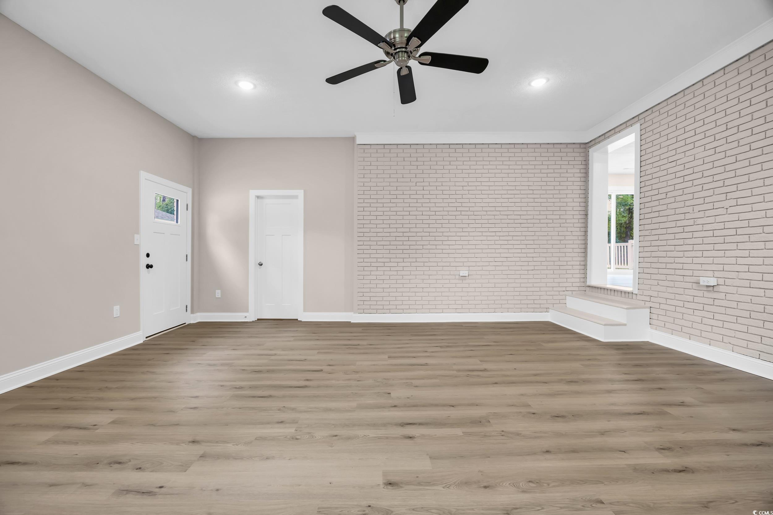 970 Virginia Drive Loris, SC 29569 - Photo 12 of 28 Unfurnished living room with brick wall, wood finished floors, a ceiling fan, and recessed lighting