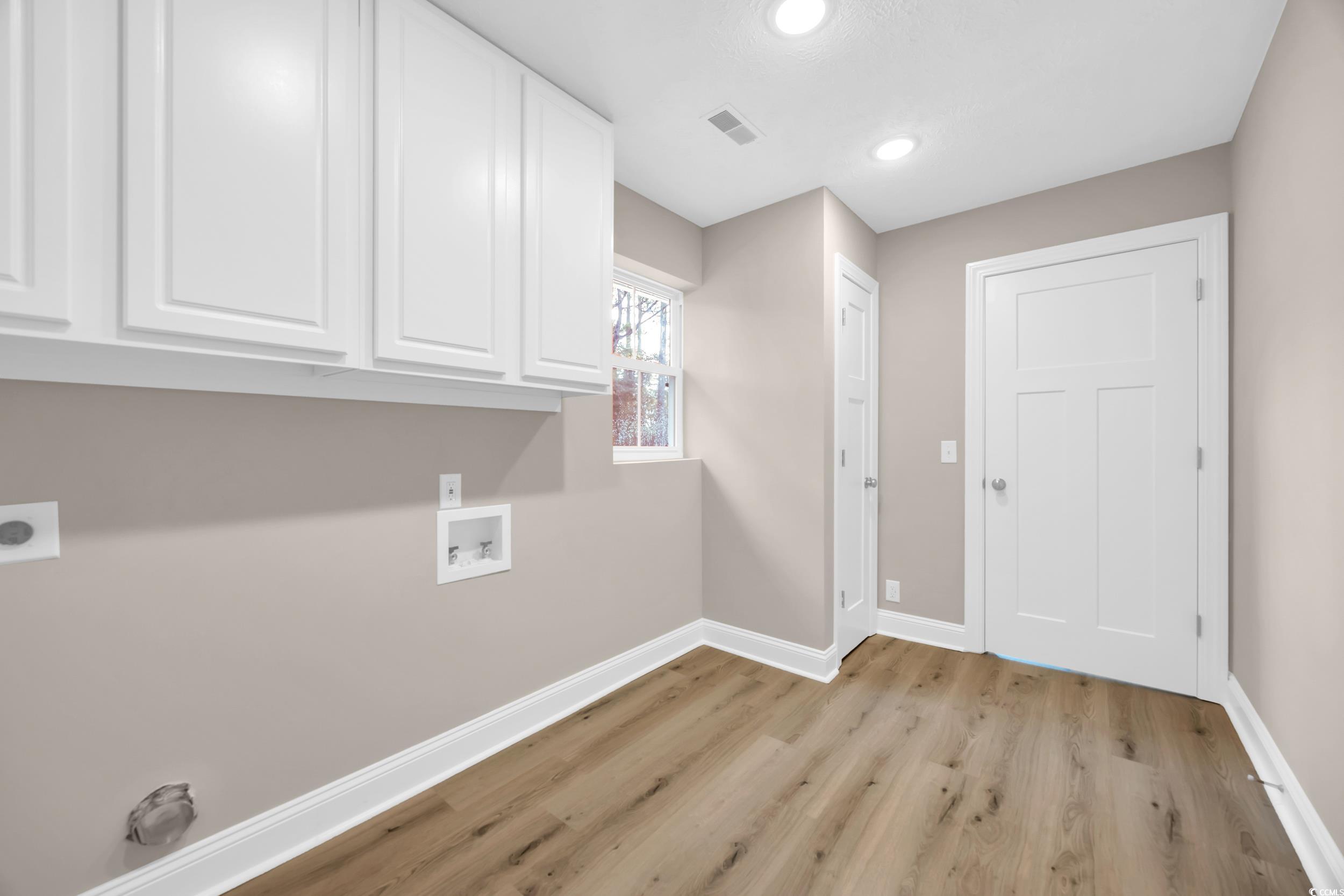 970 Virginia Drive Loris, SC 29569 - Photo 13 of 28 Laundry room with light wood finished floors, cabinet space, recessed lighting, hookup for a washing machine, and hookup for an electric dryer