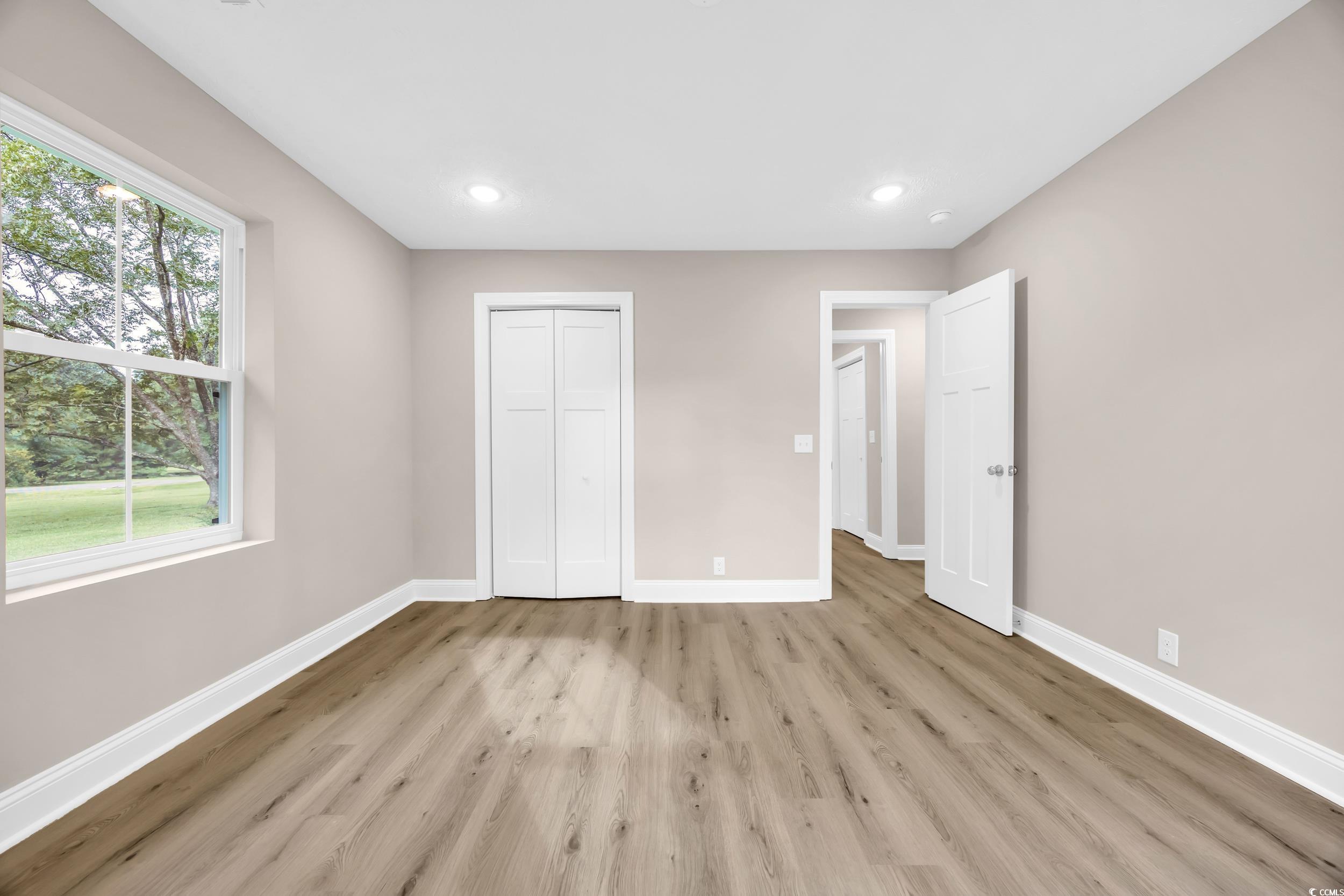 970 Virginia Drive Loris, SC 29569 - Photo 15 of 28 Unfurnished bedroom with light wood-style floors, recessed lighting, and a closet