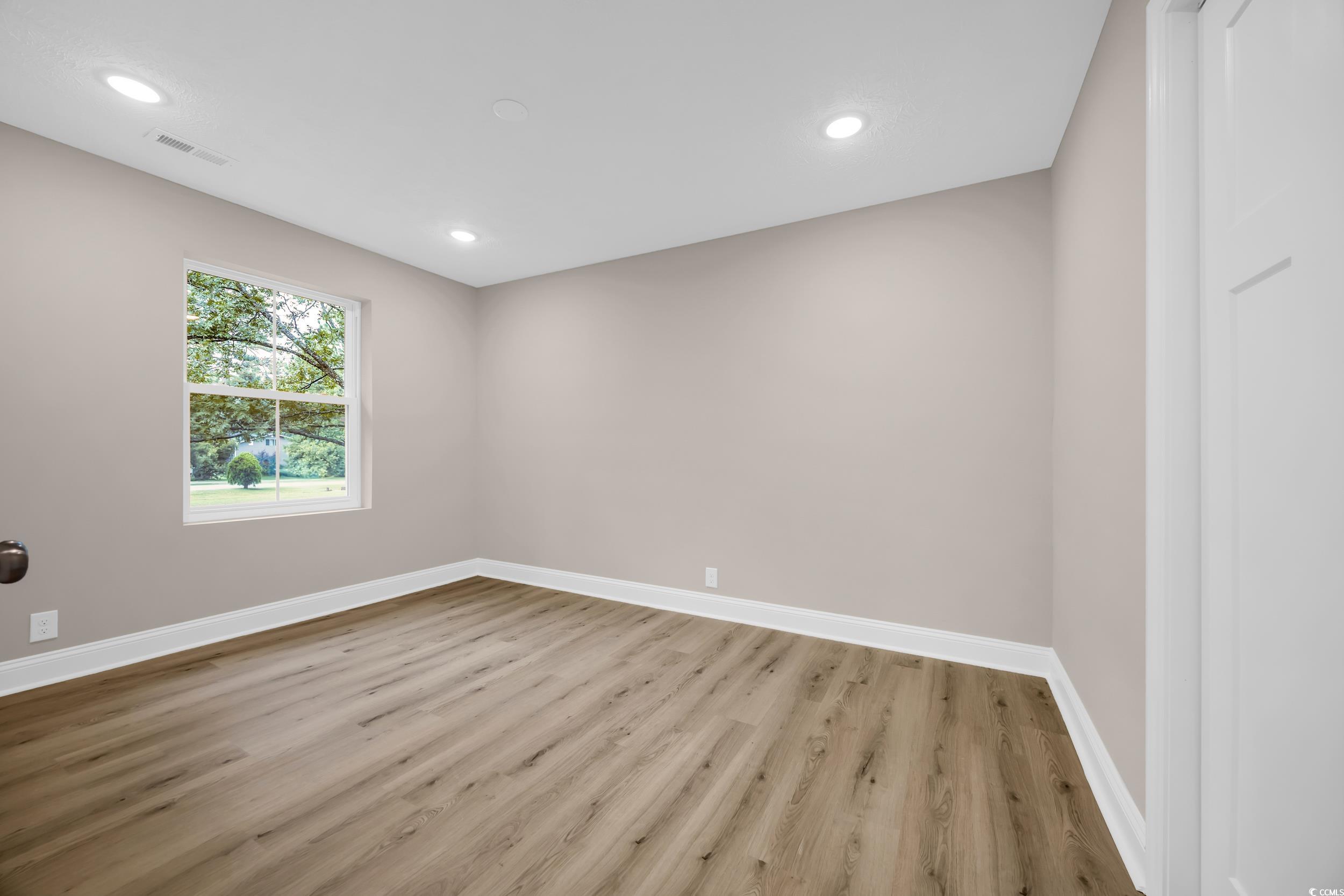 970 Virginia Drive Loris, SC 29569 - Photo 16 of 28 Spare room featuring light wood-style floors and recessed lighting