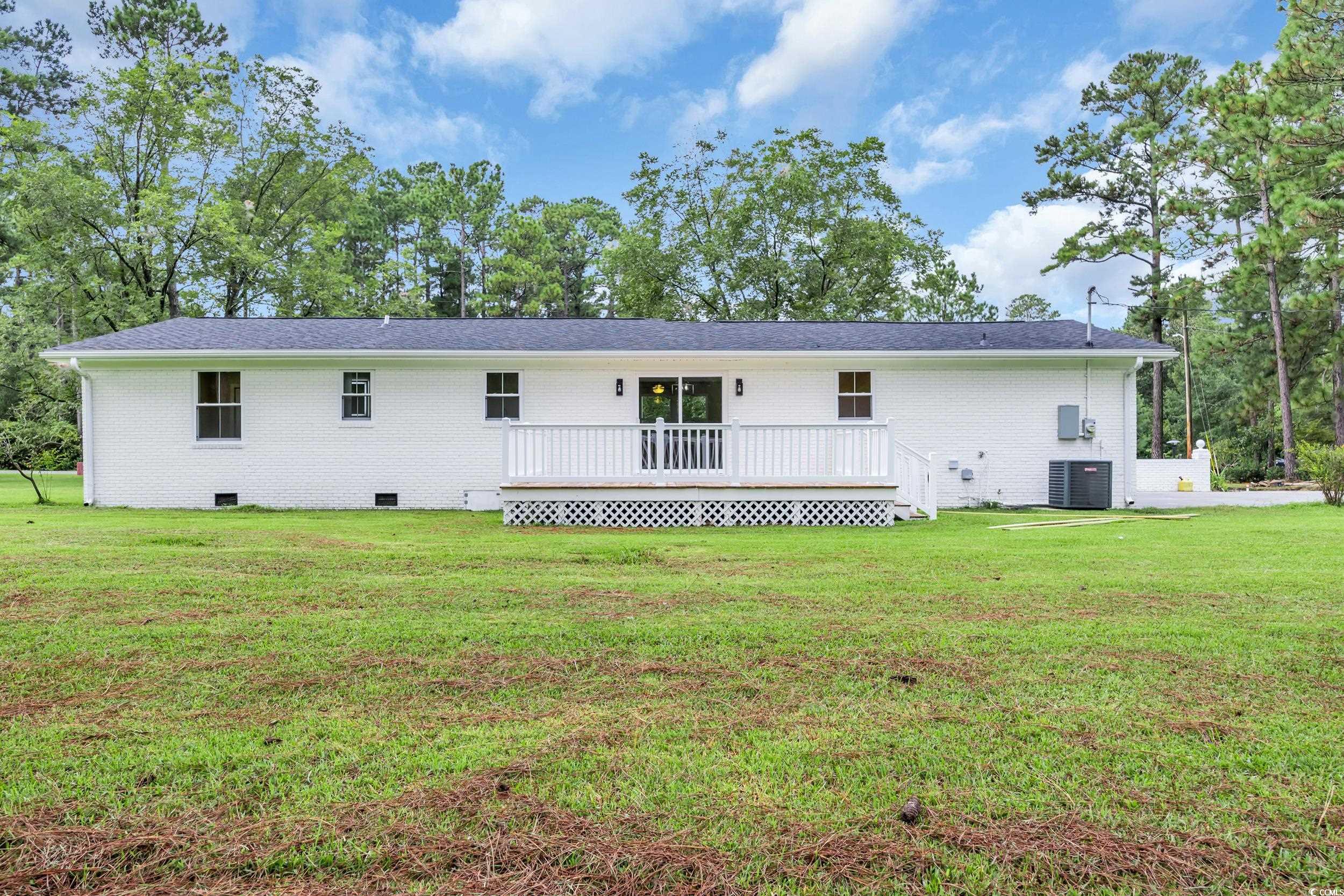970 Virginia Drive Loris, SC 29569 - Photo 21 of 28 Back of property with crawl space, brick siding, and a yard