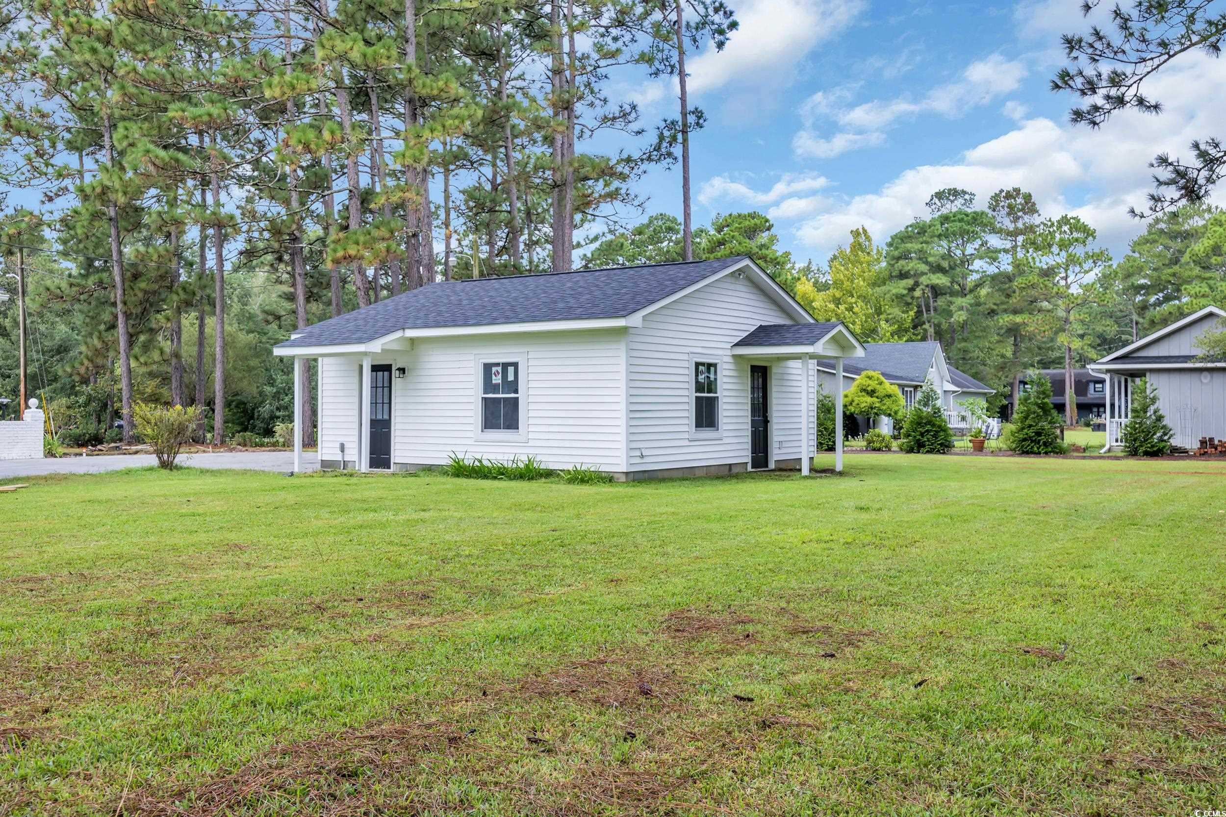 970 Virginia Drive Loris, SC 29569 - Photo 23 of 28 View of side of home with roof with shingles and a yard