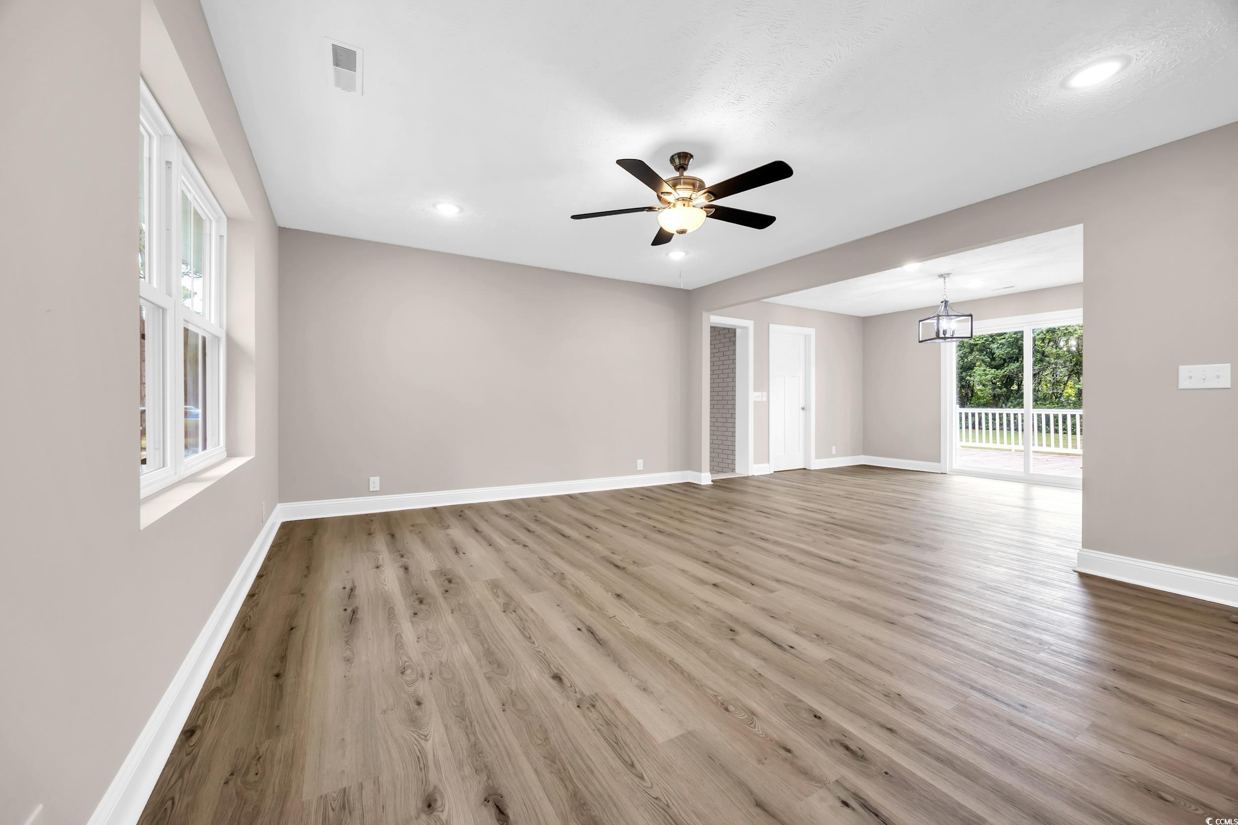 970 Virginia Drive Loris, SC 29569 - Photo 4 of 28 Empty room featuring recessed lighting, light wood-style flooring, ceiling fan, and a chandelier