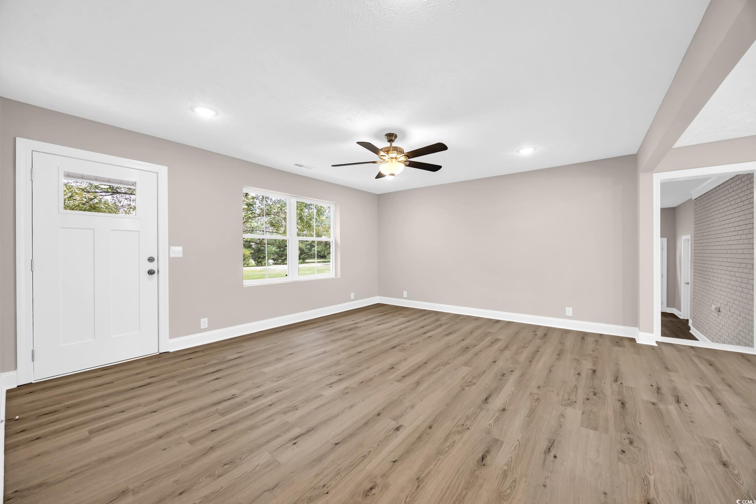 970 Virginia Drive Loris, SC 29569 - Photo 5 of 28 Unfurnished living room featuring light wood-type flooring, ceiling fan, and recessed lighting