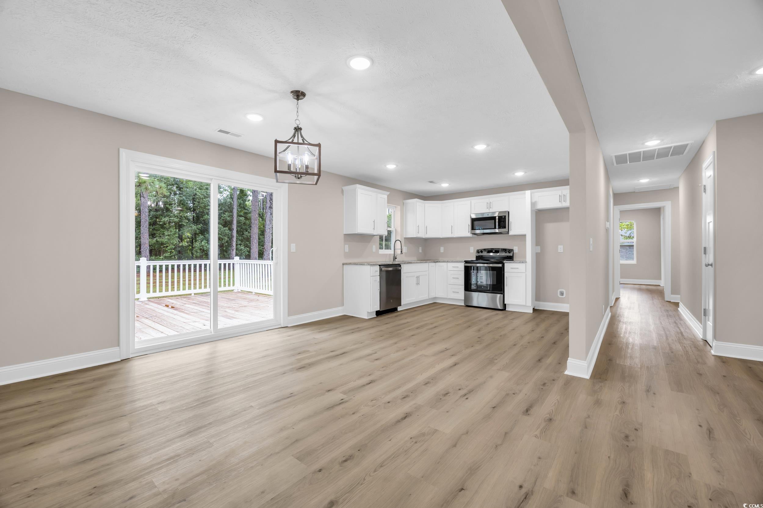 970 Virginia Drive Loris, SC 29569 - Photo 28 of 28 Kitchen with white cabinets, stainless steel appliances, light wood-style floors, recessed lighting, and open floor plan