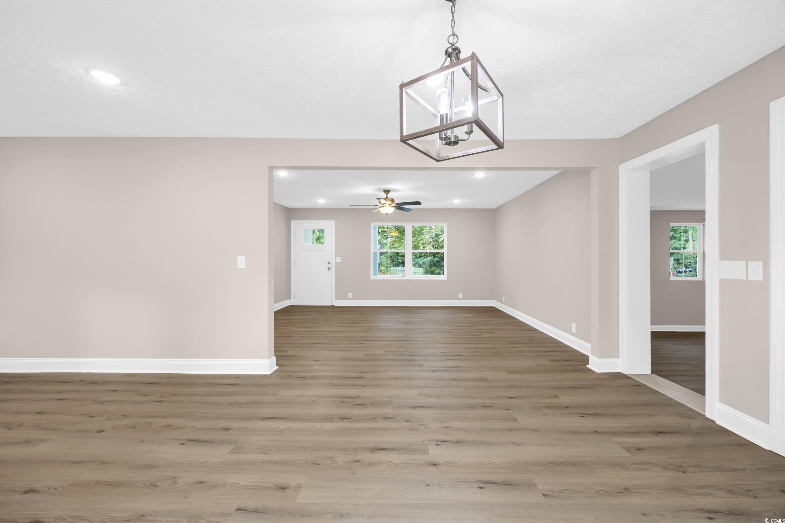 970 Virginia Drive Loris, SC 29569 - Photo 7 of 28 Unfurnished dining area featuring light wood-style floors, a chandelier, recessed lighting, and ceiling fan