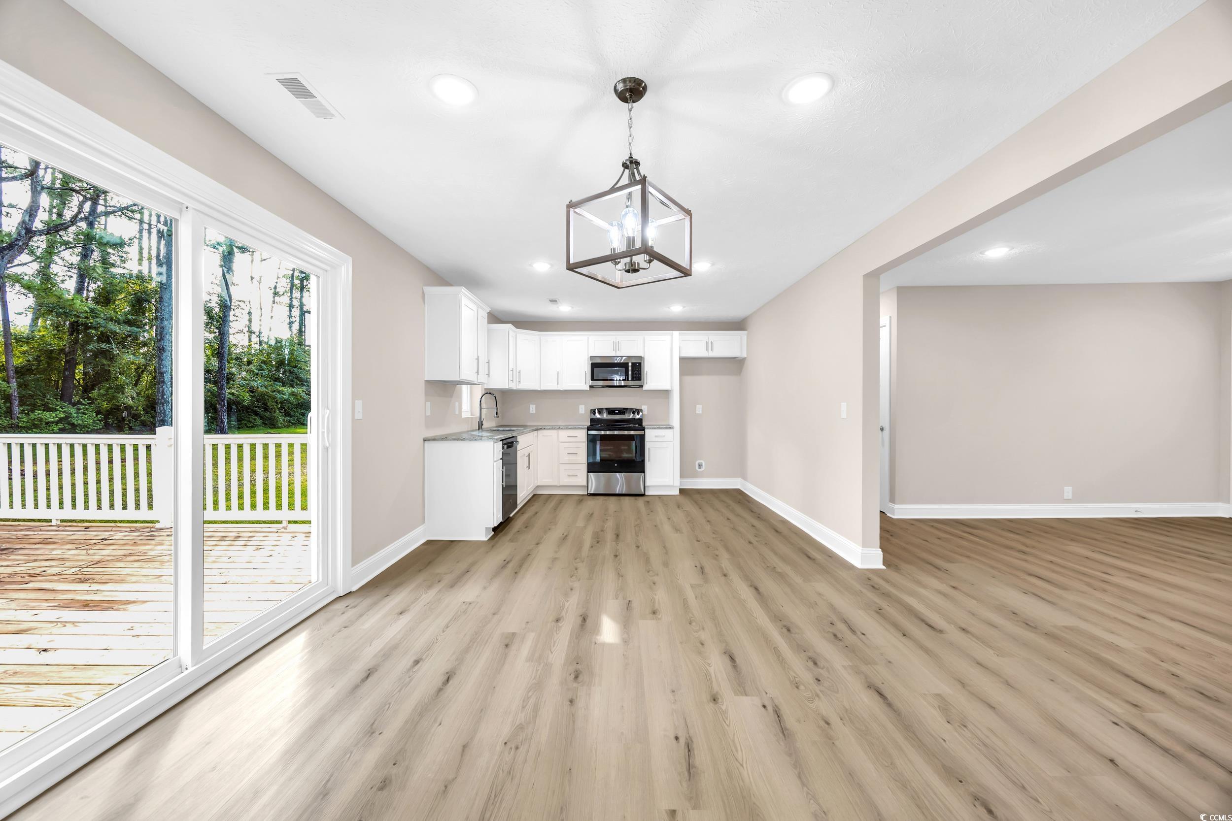 970 Virginia Drive Loris, SC 29569 - Photo 8 of 28 Kitchen with white cabinetry, light wood finished floors, stainless steel appliances, recessed lighting, and light countertops