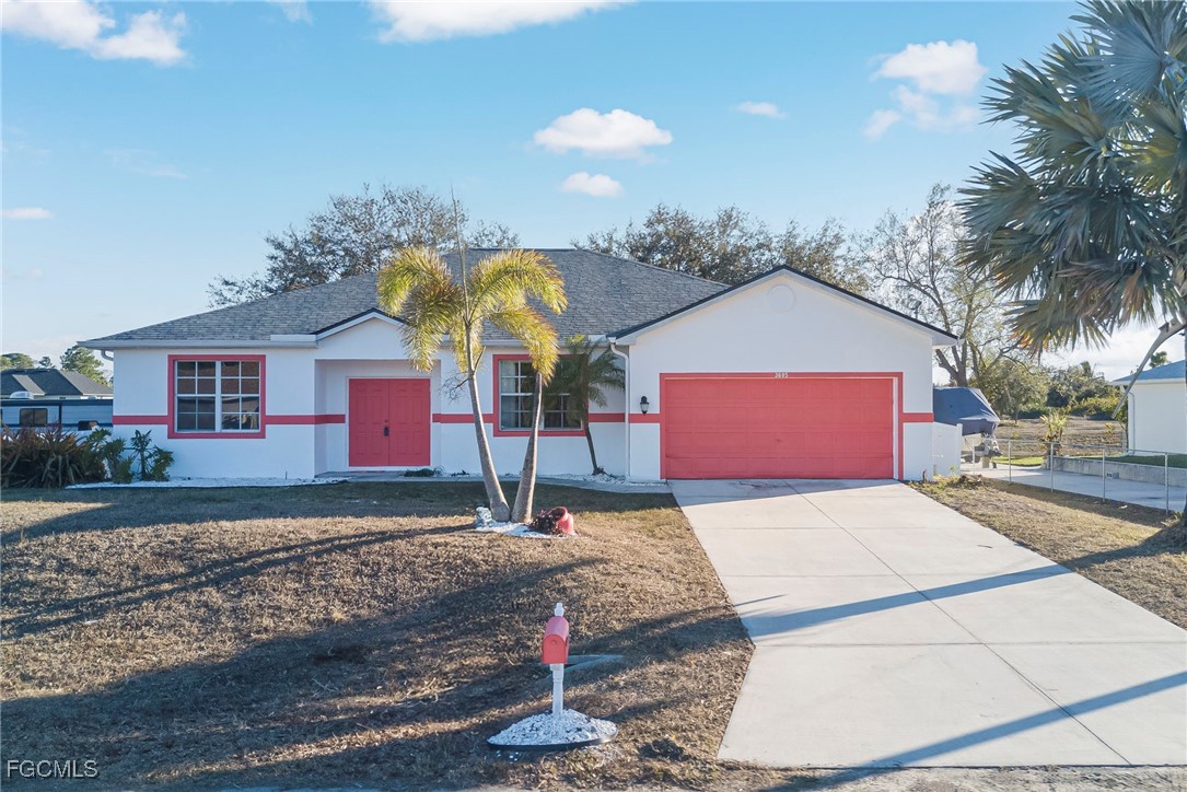 3605 17th Street West Lehigh Acres, FL 33971 - Photo 1 of 27 a front view of a house with a yard
