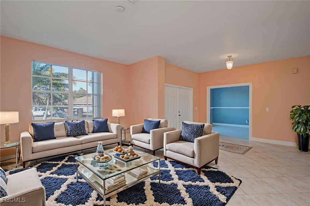 3605 17th Street West Lehigh Acres, FL 33971 - Photo 4 of 27 a living room with furniture a rug and a potted plant