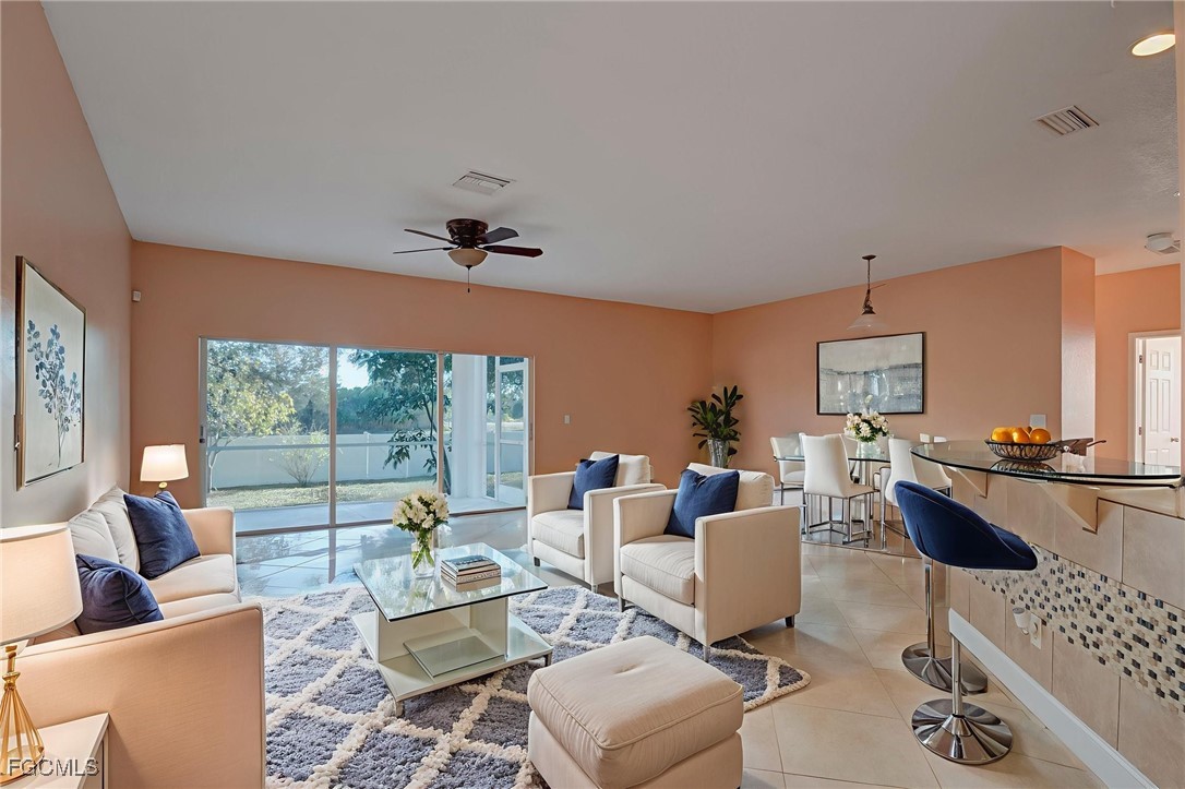 3605 17th Street West Lehigh Acres, FL 33971 - Photo 6 of 27 a living room with furniture and a large window