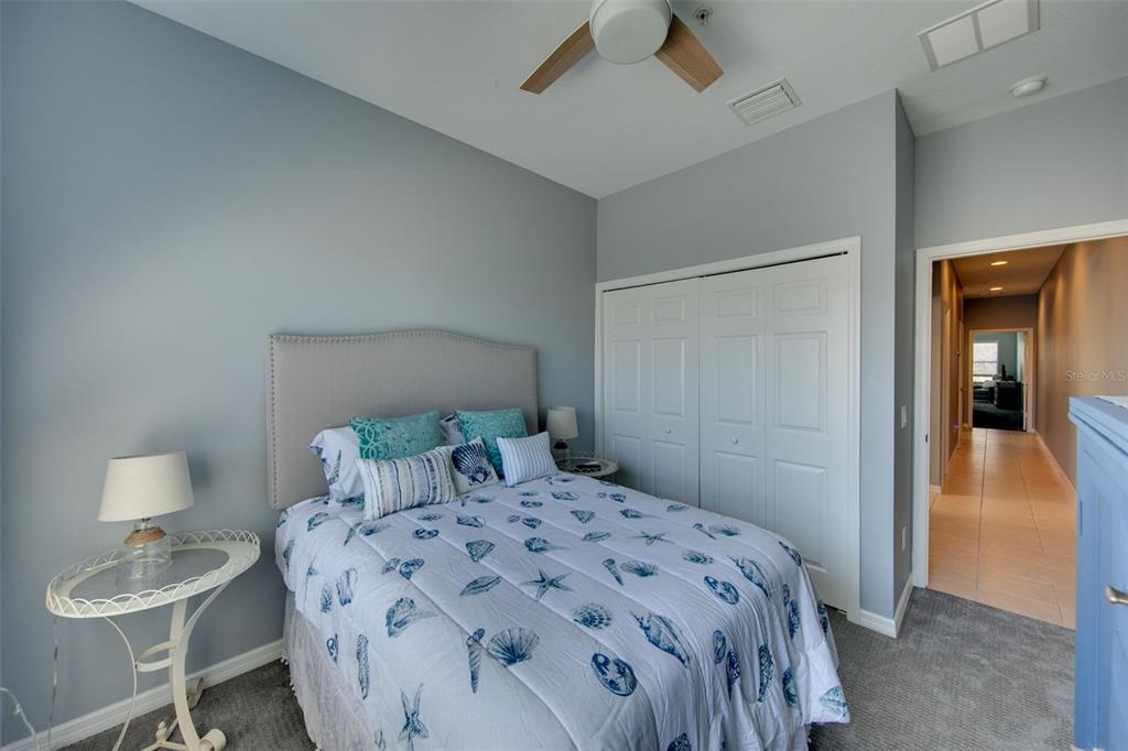 4026 Overture Circle Bradenton, FL 34209 - Photo 15 of 26 a bedroom with a bed and a lamp