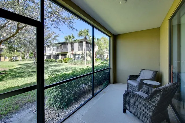a living room with furniture and floor to ceiling windows