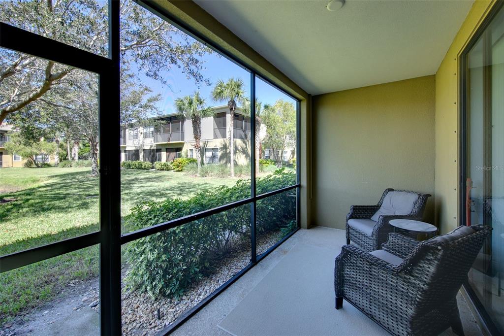 4026 Overture Circle Bradenton, FL 34209 - Photo 16 of 26 a living room with furniture and floor to ceiling windows