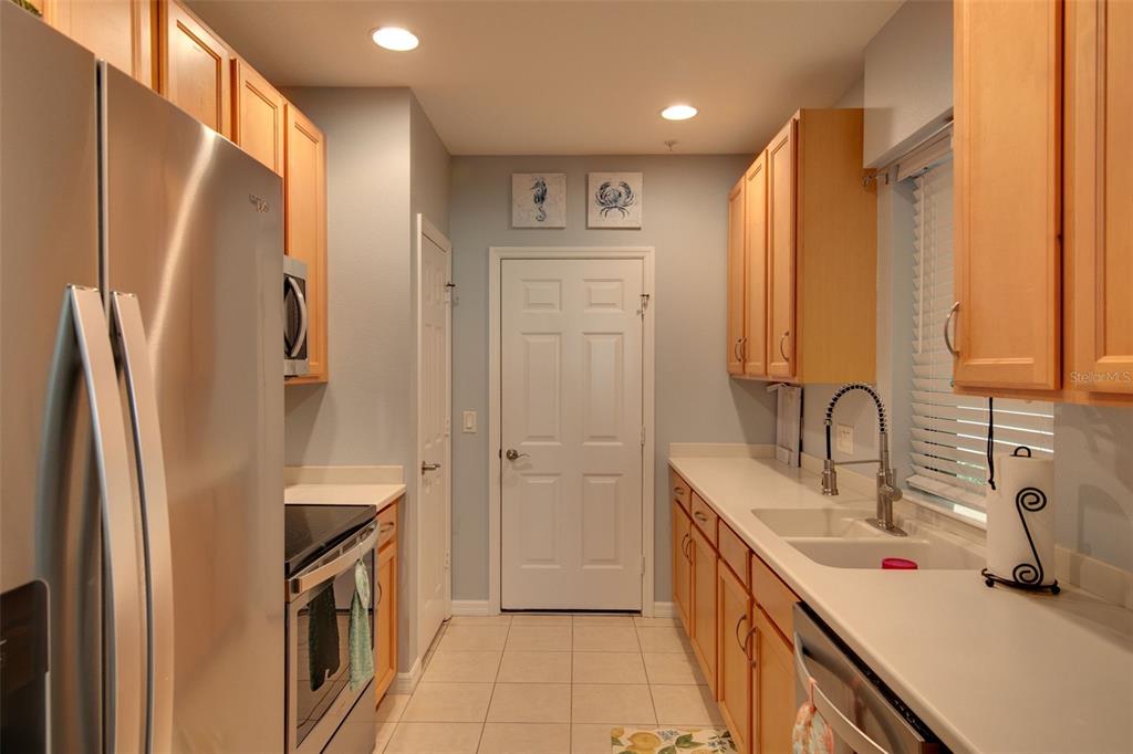 4026 Overture Circle Bradenton, FL 34209 - Photo 2 of 26 a kitchen with refrigerator a sink and cabinets