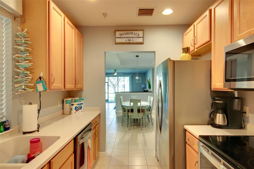 4026 Overture Circle Bradenton, FL 34209 - Photo 3 of 26 a kitchen with stainless steel appliances granite countertop a refrigerator and a stove