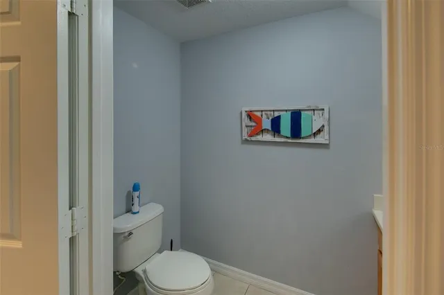 a white toilet sitting next to a bathroom sink