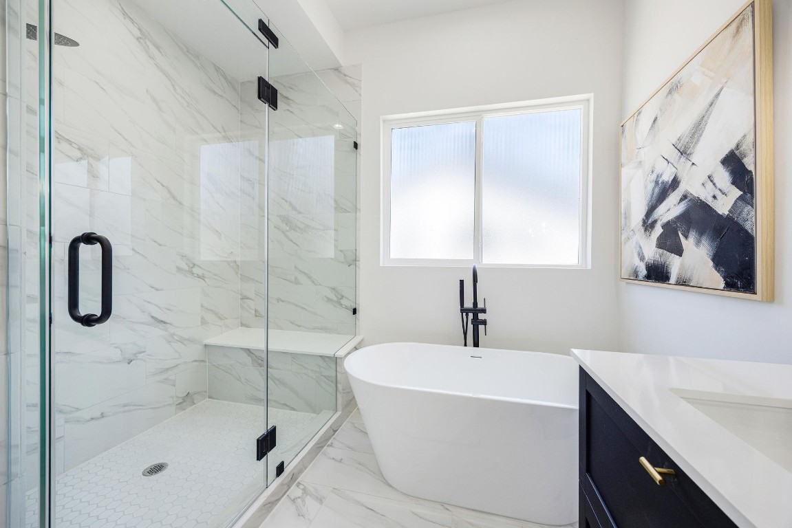 303 Marcella Street, Unit P Houston, TX 77091 - Photo 20 of 26 Primary bathroom suit with oversized walk-in shower and free-standing tub.