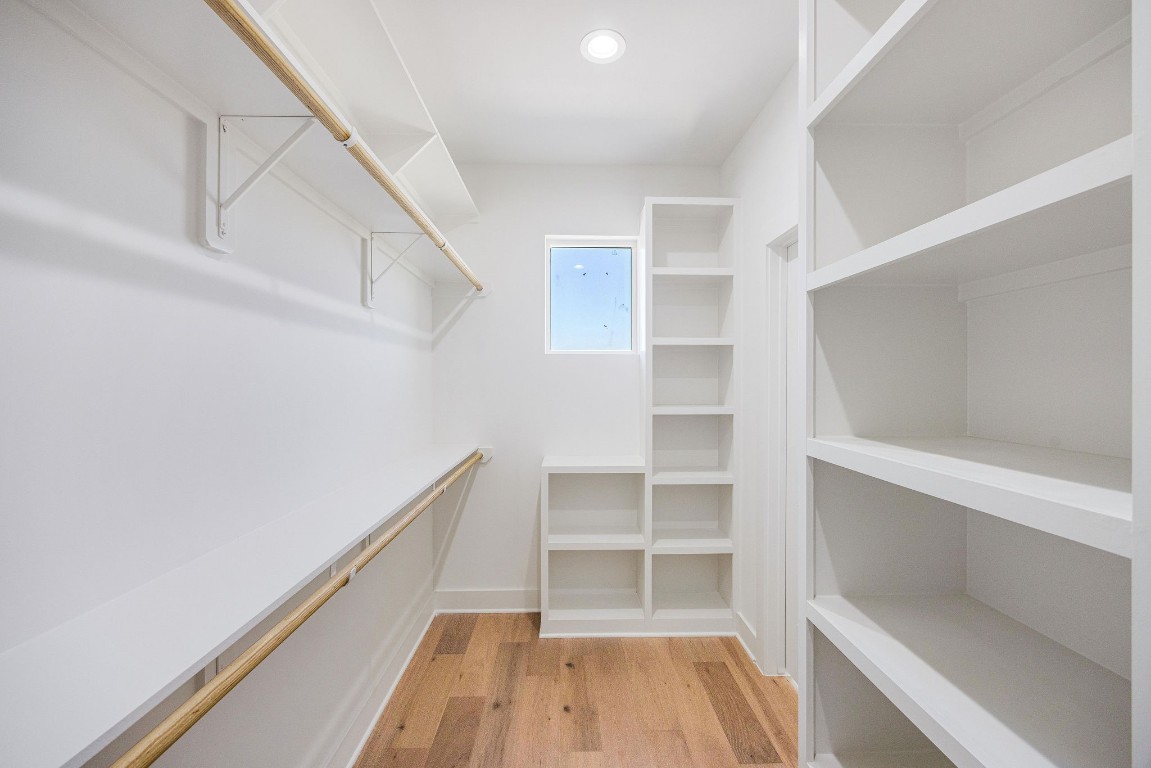 303 Marcella Street, Unit P Houston, TX 77091 - Photo 22 of 26 Large primary walk-in closet with built-in shelving.