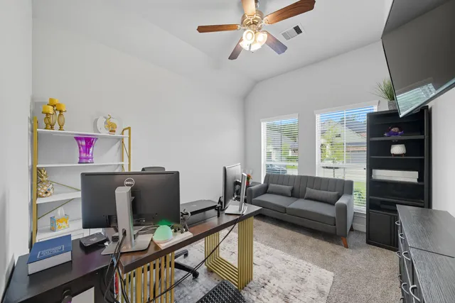 a livingroom with workspace and a couch