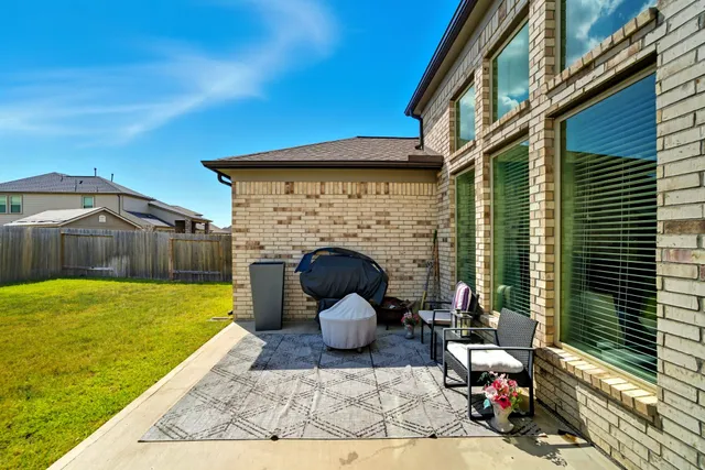 a view of a patio with a table and chairs