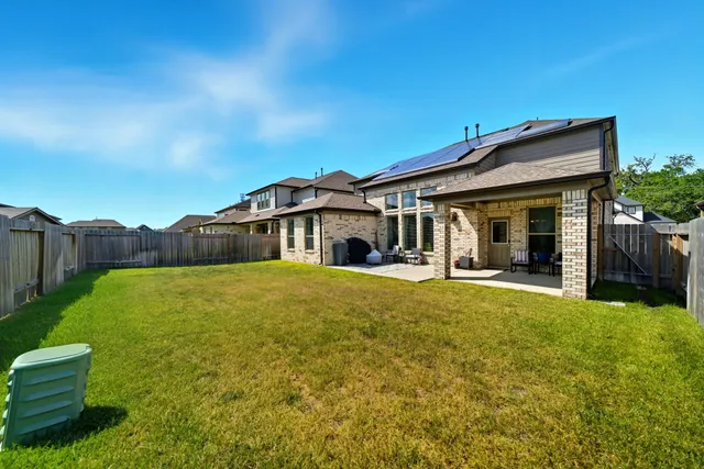 a white house with a big yard and large tree