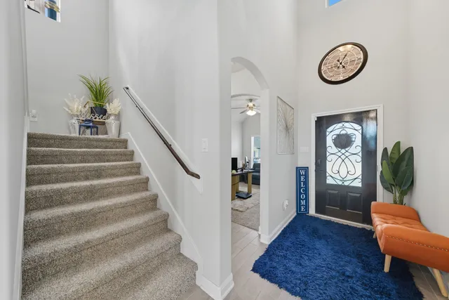 a view of entryway with wooden floor and a chandelier