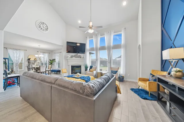 a living room with furniture a fireplace and a flat screen tv