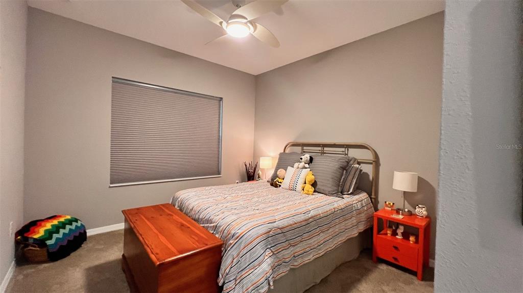 10287 Southwest 96th Lane Ocala, FL 34481 - Photo 24 of 54 a bedroom with a bed and a chandelier