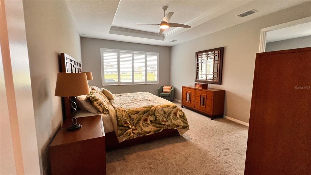 10287 Southwest 96th Lane Ocala, FL 34481 - Photo 27 of 54 a bedroom with a bed and wooden floor